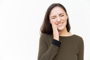 frustrated-woman-with-pain-grimace-touching-cheek