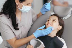 fluoride treatment appliance on a kid by a dentist